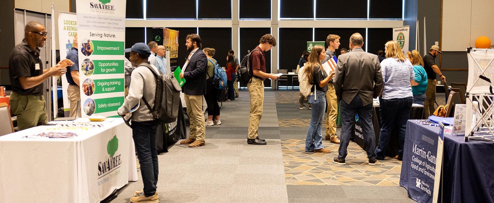 Students talking to employers tabling at a career fair.
