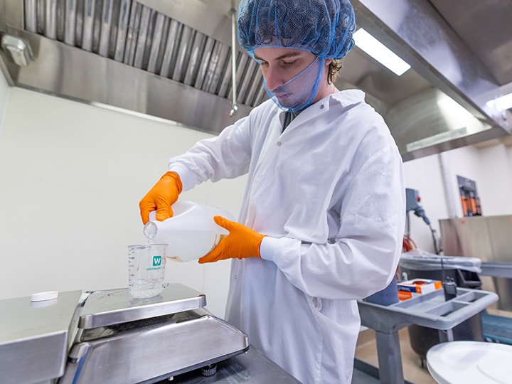 Student worker, Paul Schmudde, measures ingredients to make ice cream for the UT Creamery in the Ag Campus Food Science building on October 23, 2025. Photo by Raffe Lazarian.
