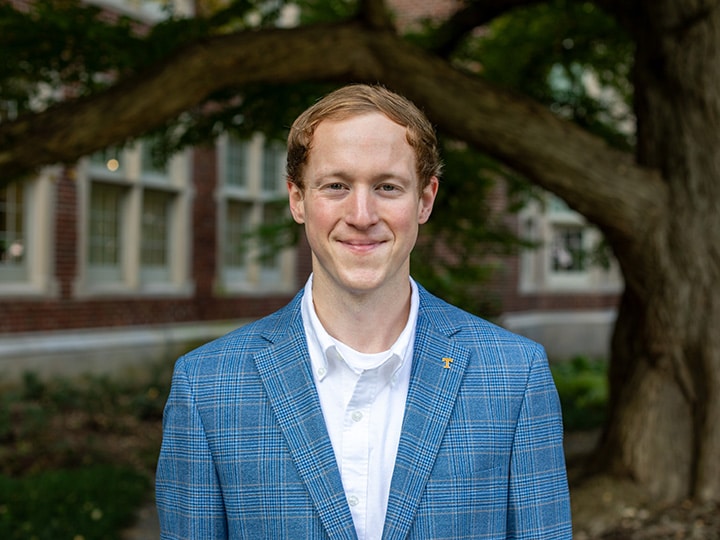 Headshot of Andrew Mills outside Morgan Hall.