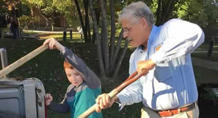 Man and child working in yard