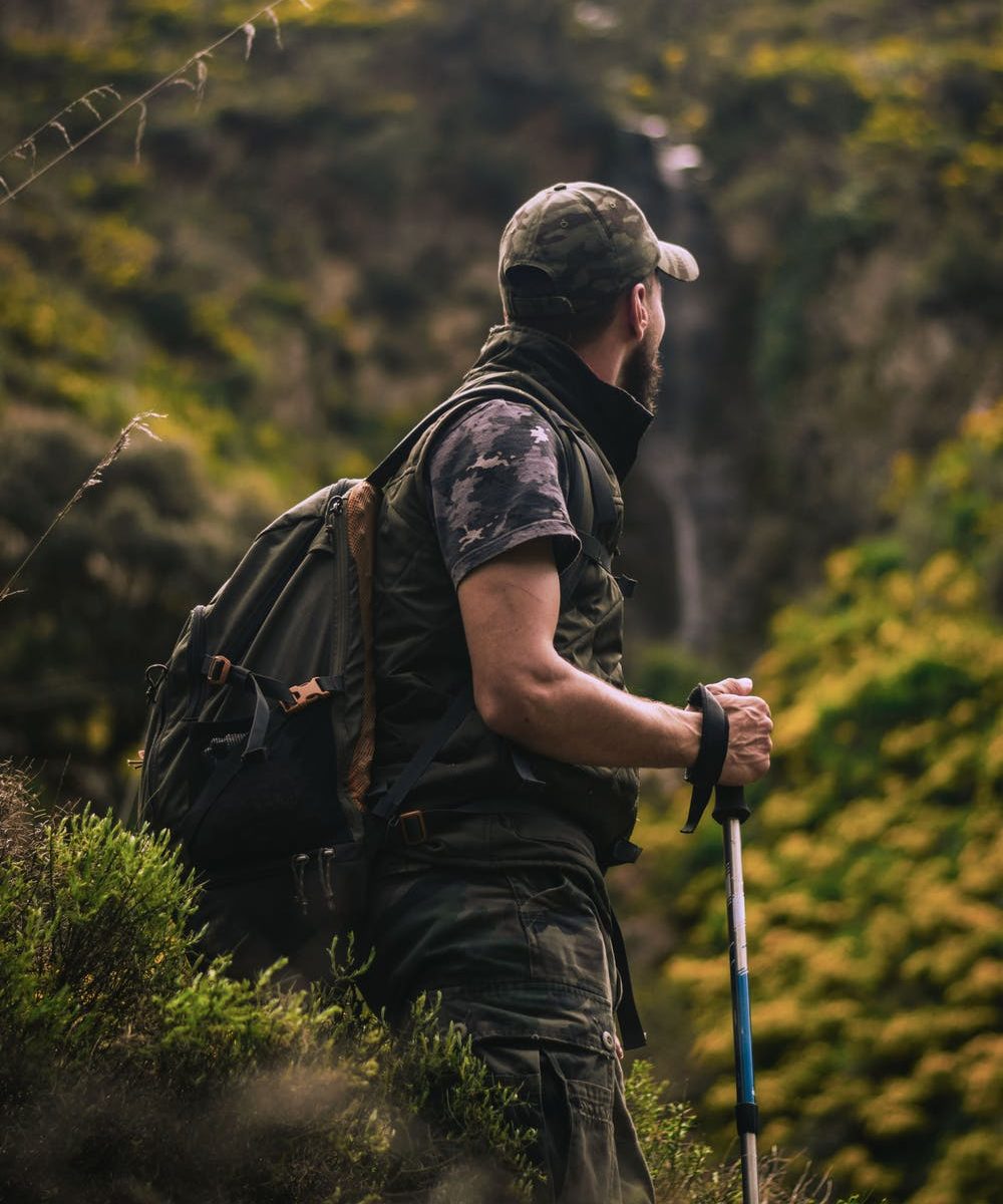 Male hiking with walking stick 