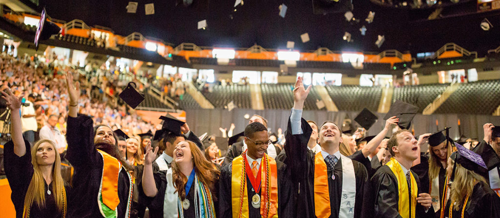 Graduating students in Thompson Boling Arena post ceremony.