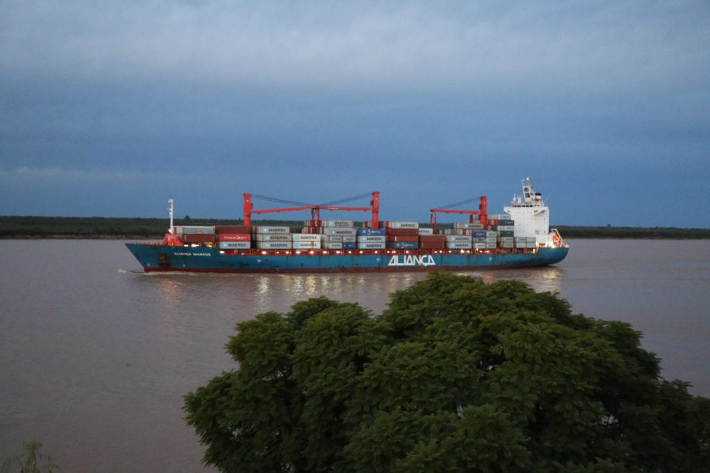 Grain is exported in cargo ships at ports on the Parana river near Rosario, Argentina.