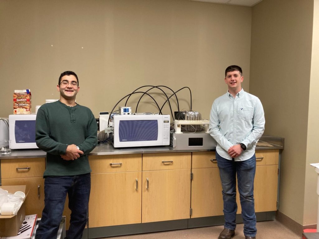 Biosystems Engineering students standing with their project.