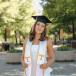 Alexandra on campus wearing a graduation cap