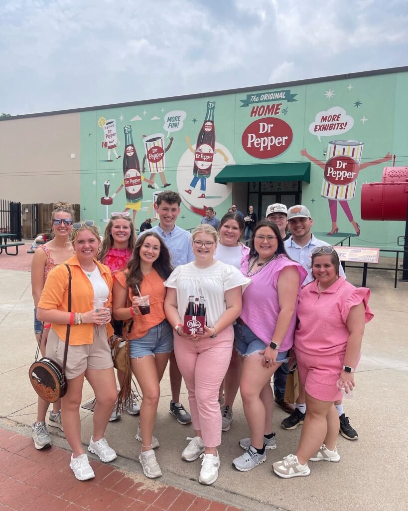 Students standing outside of the Dr. Pepper building