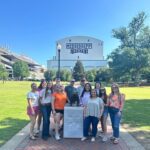 Students standing in front of the Mississippi State bulldog statue